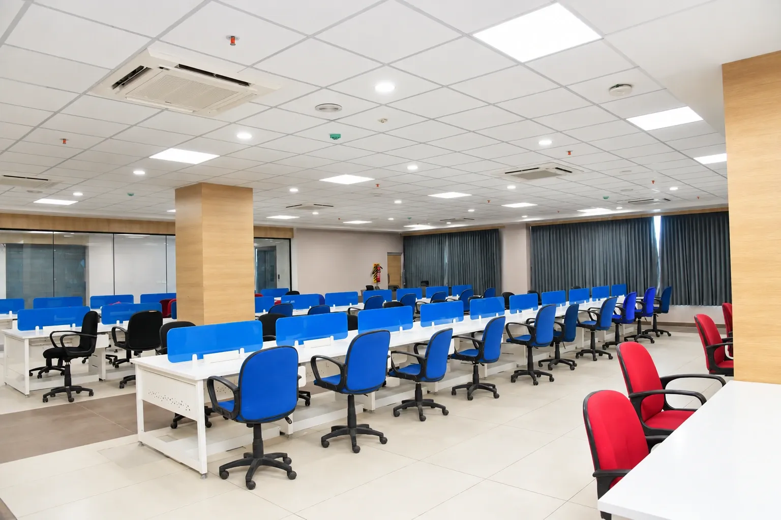 The Centizen training floor, with long white desks, blue partitions and office chairs